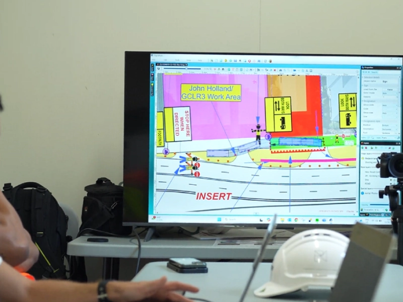 Traffic management roadwork design and traffic control layout displayed on planning monitor during coordination meeting