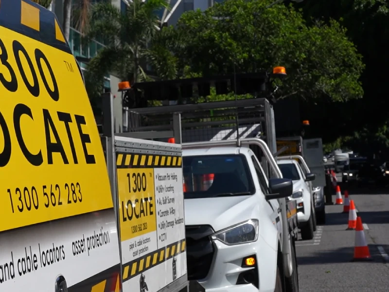 Traffic management service vehicles lined along roadside with safety cones and operational equipment